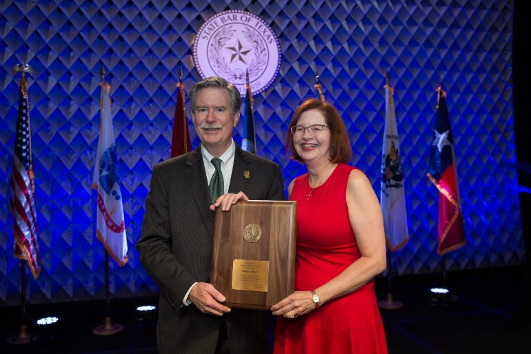 Marilyn D. McGuire, P.C. Accepting an Award Family Lawyer Accepting an Award in Cypress, TX